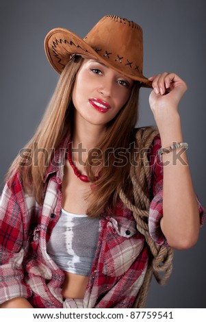 woman in cowboy hat on a gray bg