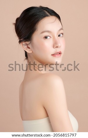 Beautiful young asian woman with clean fresh skin on beige background, Face care, Facial treatment, Cosmetology, beauty and spa, Asian women portrait. Stock foto © 