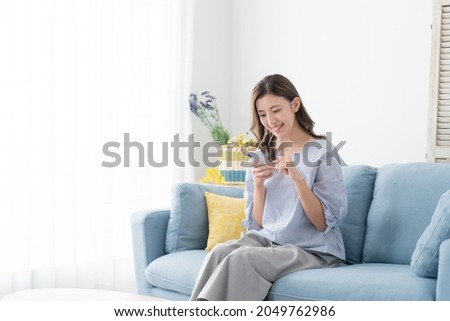 Similar – Image, Stock Photo Asian woman using smartphone at bus station