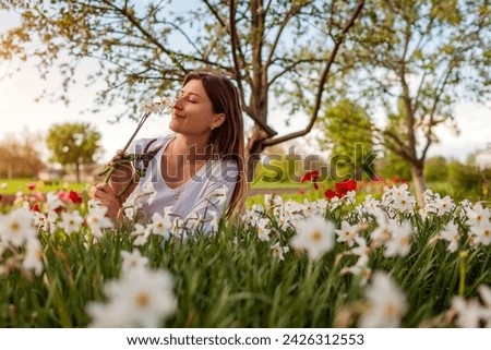 Similar – Image, Stock Photo Young woman smelling flower in the field