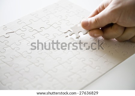 hand placing final puzzle piece in puzzle