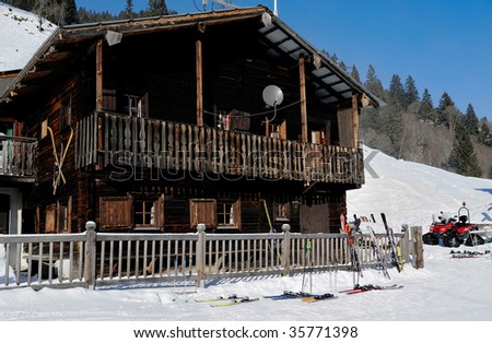 ski standing at the fence of a ski lodge