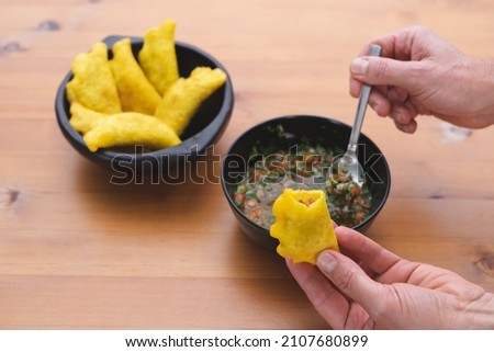 Colombian Empanadas. Hand filling an empanada with hot bell pepper. Copy space. Colombian cuisine. Foto stock © 
