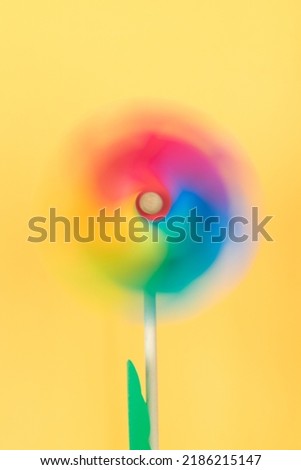 Similar – Image, Stock Photo Moving colored pinwheel on yellow background. Place to copy.