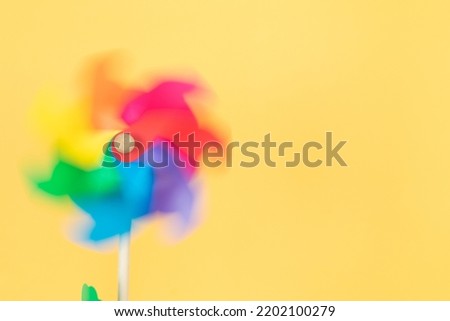 Similar – Image, Stock Photo Moving colored pinwheel on yellow background. Place to copy.