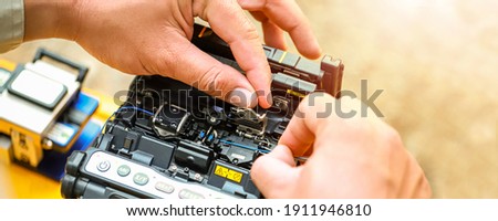Banner template Technician Fiberoptic Fusion Splicing. Worker connecting for Cable Internet signal and Wire connection with Fiber Optic Fusion Splicing machine,fiber optic cable splice machine in work