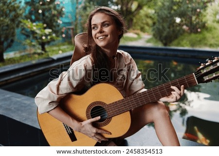 Image, Stock Photo Calm woman playing guitar in bedroom