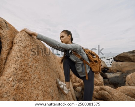 Similar – Image, Stock Photo Coastal landscape and girl in yellow hooded coat looking at sea and walking. Copy space.