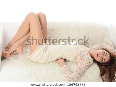 The beautiful woman. The woman in a white dress on a white sofa. isolated on white background