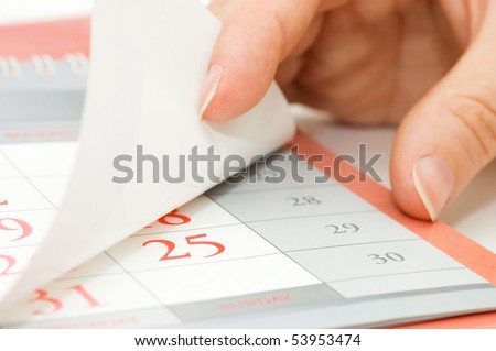 The hand overturns calendar sheet