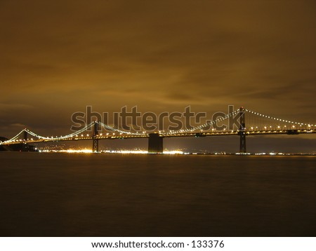 The bay bridge and east bay city lights, in San Francisco at night.