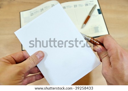 Two hands opening envelope using envelope knife.