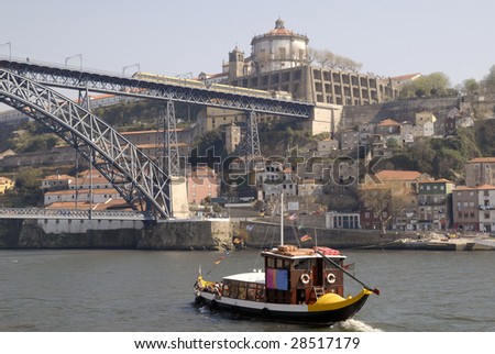 View of Porto city, Portugal. Porto city, excursion boat in the river Douro and the Bridge of Luis I with tram, Portugal.  It was made by design o? Gustaf Eiffel. Point og interest in Portugal.
