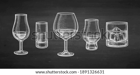 Whiskey glasses. Chalk sketch on blackboard background. Hand drawn vector illustration. Retro style.