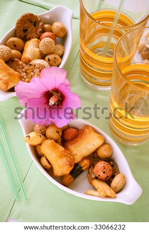 Rice snacks served with a flower and two long drink glasses on the table