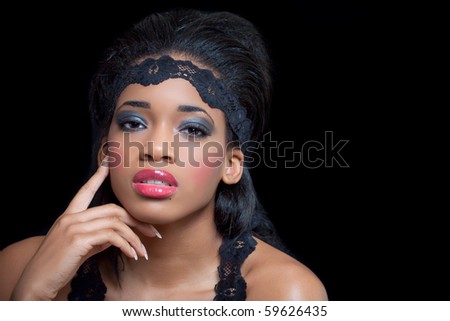 Portrait of a sensual young black woman, isolated on black