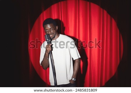Image, Stock Photo Man holds a microphone in his hand ready to speak