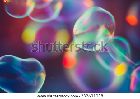 Soap bubbles floating in the air as the Summer sun sets