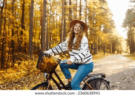 Similar – Image, Stock Photo Woman with bicycle walking in park