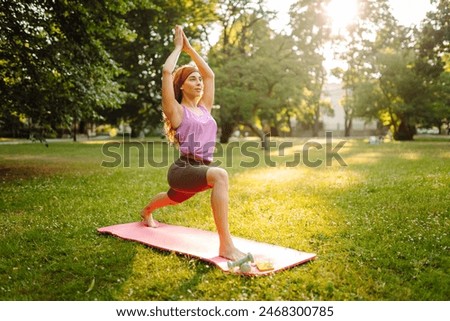 Similar – Foto Bild Frau macht Gleichgewichtsübung in Baumhaltung während sie Yoga auf der Straße praktiziert