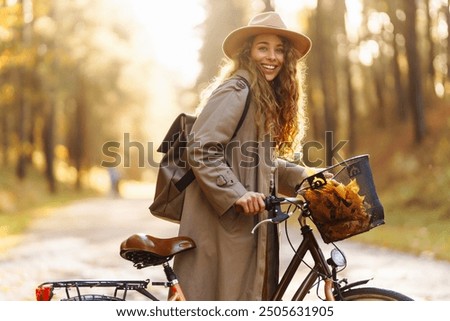 Similar – Image, Stock Photo Beautiful woman in autumn park wearing a burgundy beret, holding a red maple leaf. Young woman with long hair in stylish fall outfit, smiling and looking to the camera.