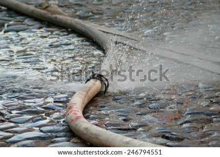 Kyiv, Ukraine - July 2, 2008: Fire hose is leaking. A fire in a warehouse at 108 Frolovska
