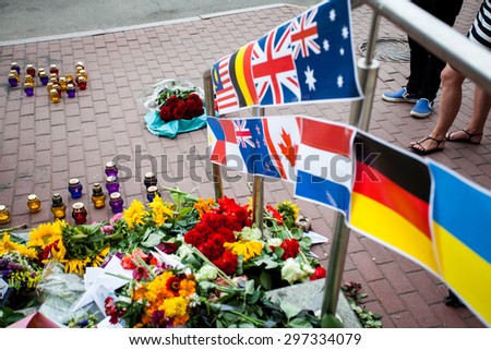 Kiev, Ukraine -  17 July 2015: People place flowers and light candles in commemoration of the victims of Malaysia Airlines MH17 plane accident in eastern Ukraine, in front of the Dutch embassy