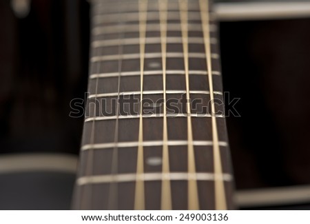 close-up macro of guitar strings and fret board
