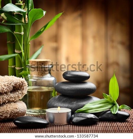 zen basalt stones and spa oil on the wood