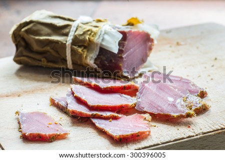 smoked wild boar meat on the wooden board