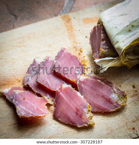 smoked wild boar meat on the wooden board