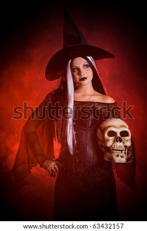 Halloween witch with a skull over black background with red smoke