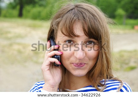 The girl talks on mobile telephone