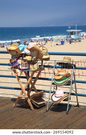 SANTA MONICA, CALIFORNIA - JULY 1: A display selling beach hats on the Santa Monica Pier on July 1, 2012 in Santa Monica, California. The pier opened in 1909 and now has an aquarium and a carousel.