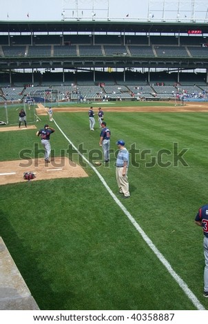 CHICAGO - MAY 27 : Famous Wrigley Field foul line view of the Atlanta Braves warm ups prior to an early season Cubs baseball game on May 27, 2006 in Chicago.