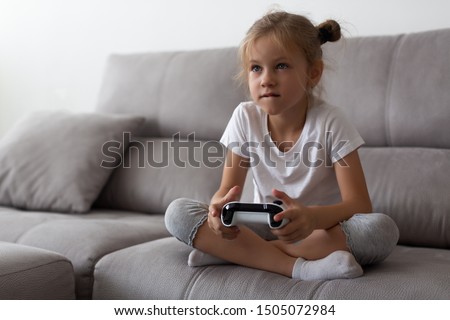 Similar – Image, Stock Photo Serious kid playing with toy at home