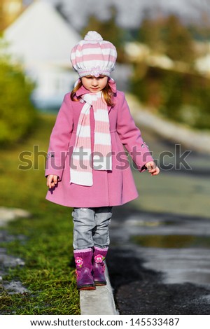 Young girl walking in the park in spring day (shallow dof)
