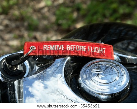 Closeup motorbike gas tank, speedometer and inscription on the key (remove before flight)