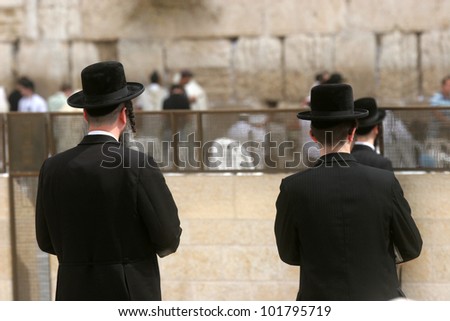 JERUSALEM - OCTOBER 03: Jewish men pray at the western wall October 03, 2006 in Jerusalem, IL. The wall is one of the holiest sites in Judaism attracting thousands of worshipers daily.