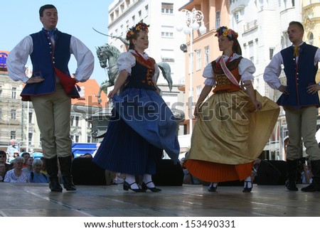 ZAGREB,CROATIA - JULY 18: Members of the ensemble song and dance Warsaw School of Economics in Polish national costume during the 47th International Folklore Festival Zagreb,Croatia on July 18,2013