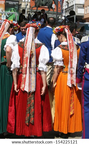 ZAGREB,CROATIA - JULY 18: Members of the ensemble song and dance Warsaw School of Economics in Polish national costume during the 47th International Folklore Festival in Zagreb,Croatia on July 18,2013