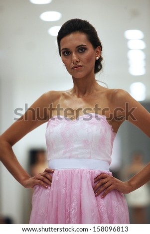 ZAGREB, CROATIA - OCTOBER 12: Fashion model in cocktail dress made by Ana Milani on 'Wedding Expo' show in the Westgate Shopping City in Zagreb, Croatia on October 12, 2013