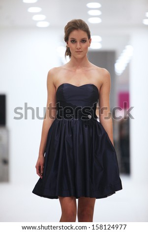 ZAGREB, CROATIA - OCTOBER 12: Fashion model in cocktail dress made by Lorien on \'Wedding Expo\' show in the Westgate Shopping City in Zagreb, Croatia on October 12, 2013