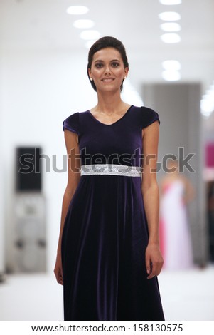 ZAGREB, CROATIA - OCTOBER 12: Fashion model in cocktail dress made by Miss B on \'Wedding Expo\' show in the Westgate Shopping City in Zagreb, Croatia on October 12, 2013