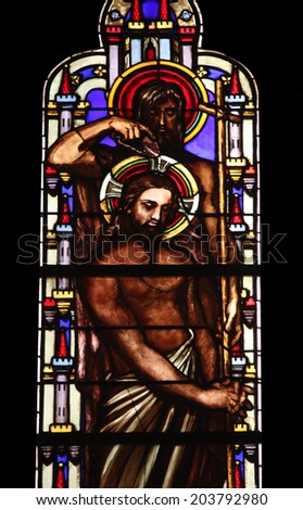 PARIS, FRANCE - NOV 11, 2012: Baptism of the Lord, stained glass from Church of St-Germain-l'Auxerr ois founded in the 7th century, was rebuilt many times over several centuries.