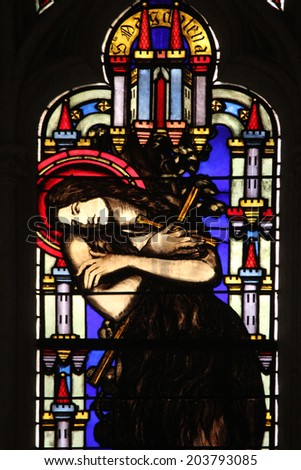 PARIS, FRANCE - NOV 11, 2012: Maria Magdalena, stained glass from Church of St-Germain-l\'Auxerr ois founded in the 7th century, was rebuilt many times over several centuries.