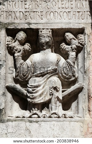 PARMA,ITALY-MAY 01, 2014:Faith(holding Justice and Peace)relief at the baptistery from Benedetto Antelami.Baptistery in Parma is considered to be among the most important Medieval monuments in Europe.