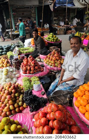 KOLKATA, INDIA - FEBRUARY 11: Street trader sell fruits outdoor on February 11, 2014 in Kolkata India. Only 0.81% of the Kolkata\'s workforce employed in the primary sector (agriculture)