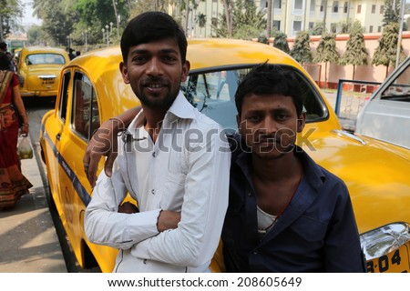 KOLKATA, INDIA - FEBRUARY 14: Indian taxi driver posing in front of his cab in Kolkata on February 14, 2014. The car is Hindustan Ambassador, manufactured since 1958.
