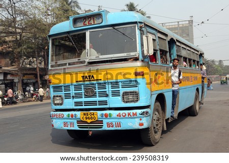KOLKATA, INDIA - FEBRUARY 08:People on the move come in the colorful bus on February 08, 2013 in Kolkata, India. Kolkata and its suburbs, is home to approximately 14.1 million people.